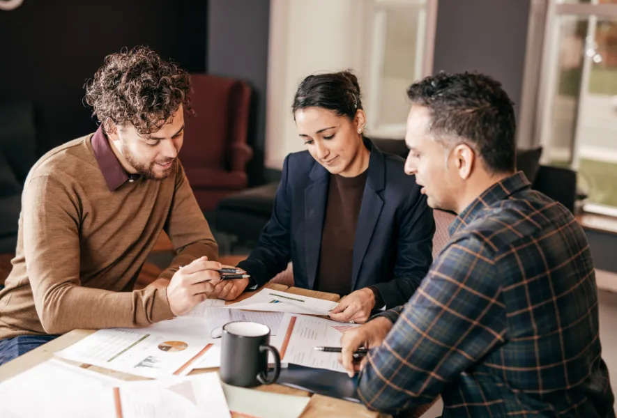 millennial couple talking to mortgage professional